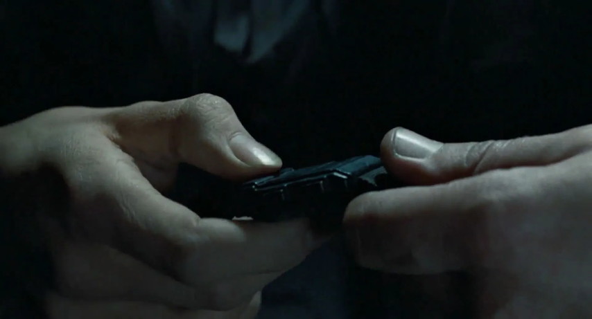 An image from the movie "Aliens". Hicks hands Ripley a tracking bracelet.